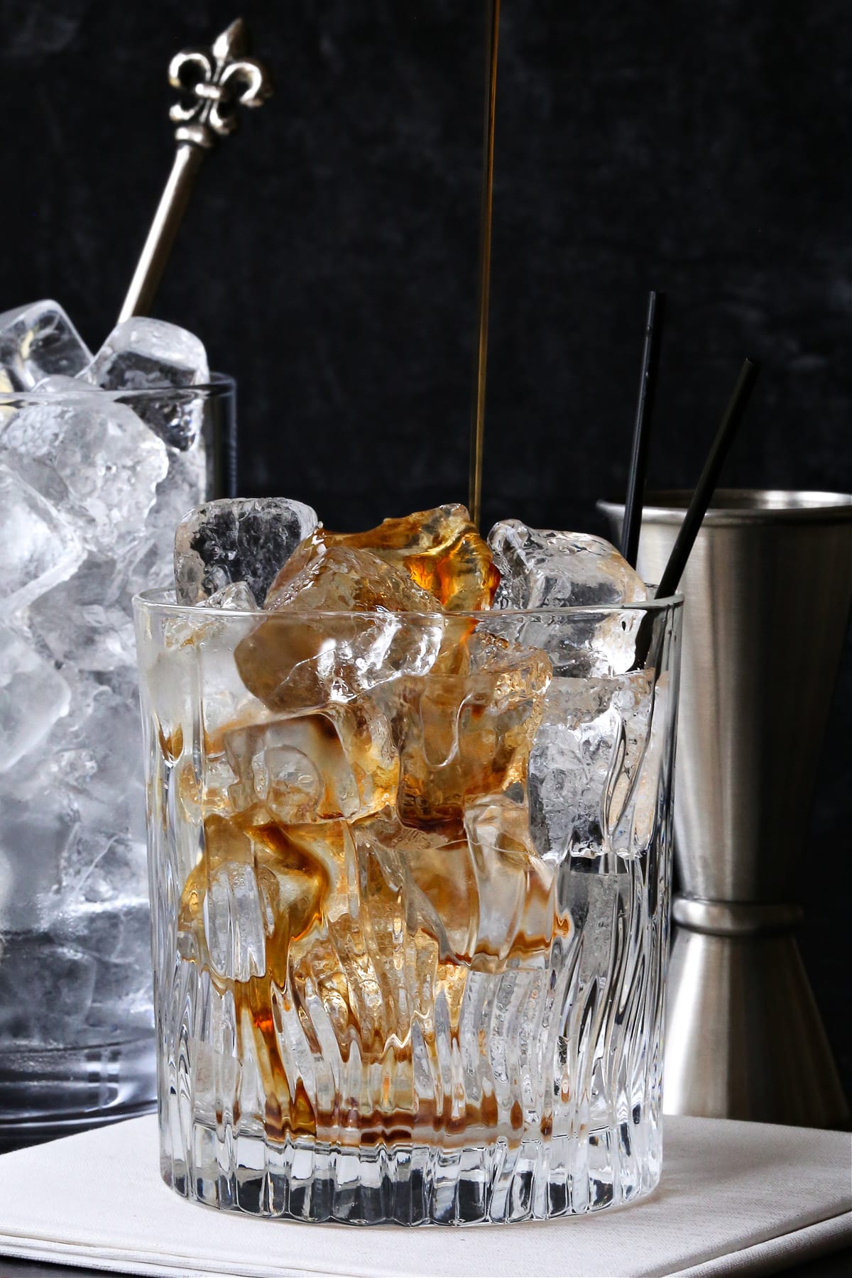 kahlua being poured into low ball glass with ice