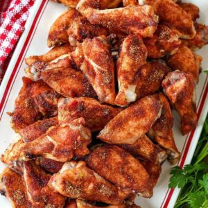 Seasoned baked chicken wings on a platter