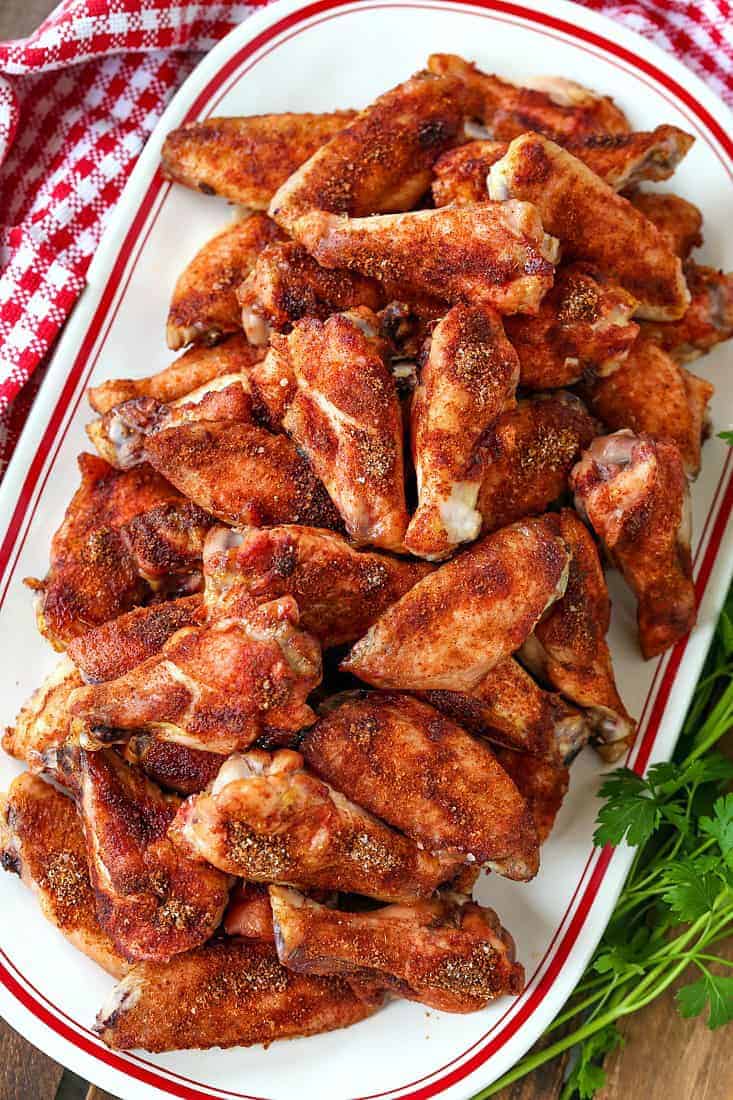 Seasoned baked chicken wings on a platter