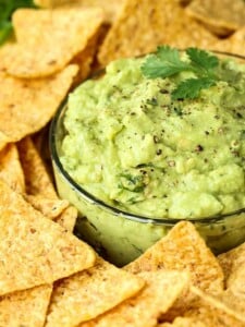 Easy Guacamole recipe in a bowl with fresh pepper and chips