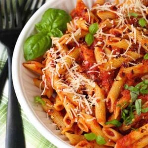 Pasta with Homemade Arrabbiata Sauce in a white bowl with basil