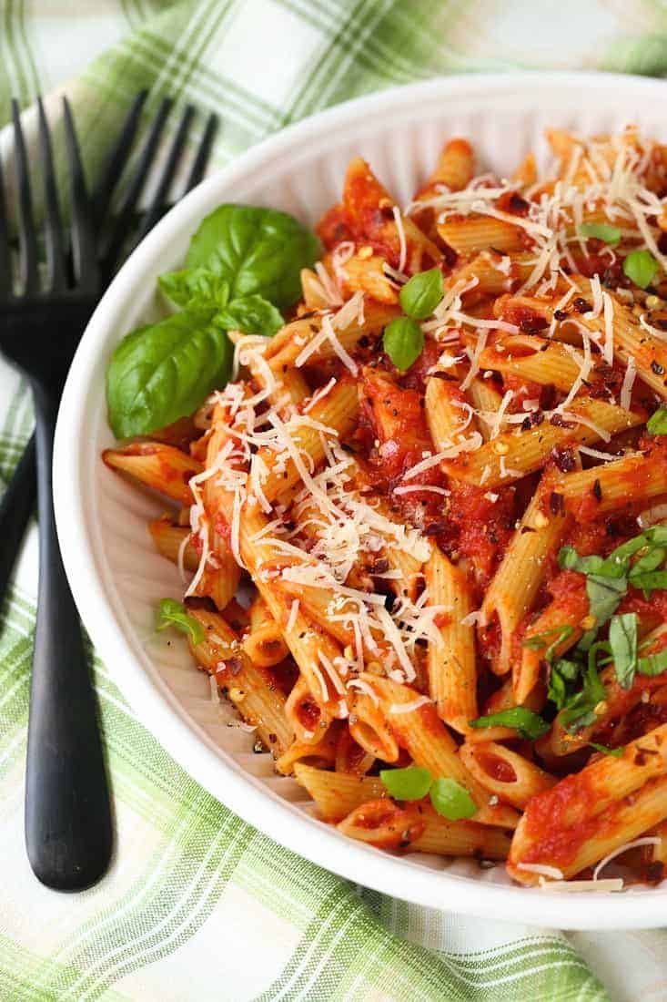 Pasta with Homemade Arrabbiata Sauce in a white bowl with basil