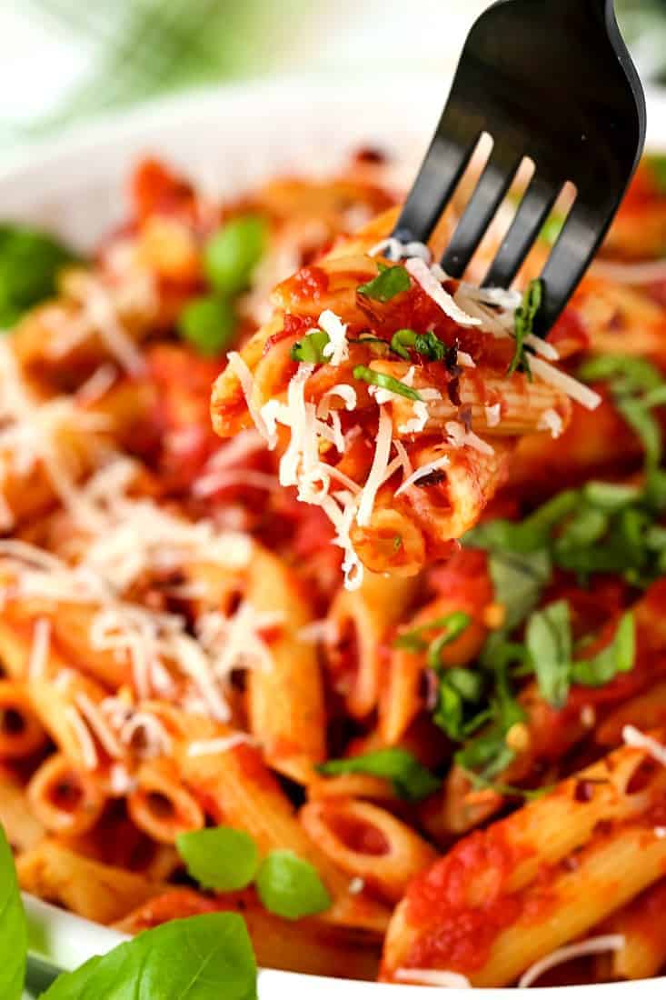 Penne arrabbiata with shredded parmesan cheese and fresh basil