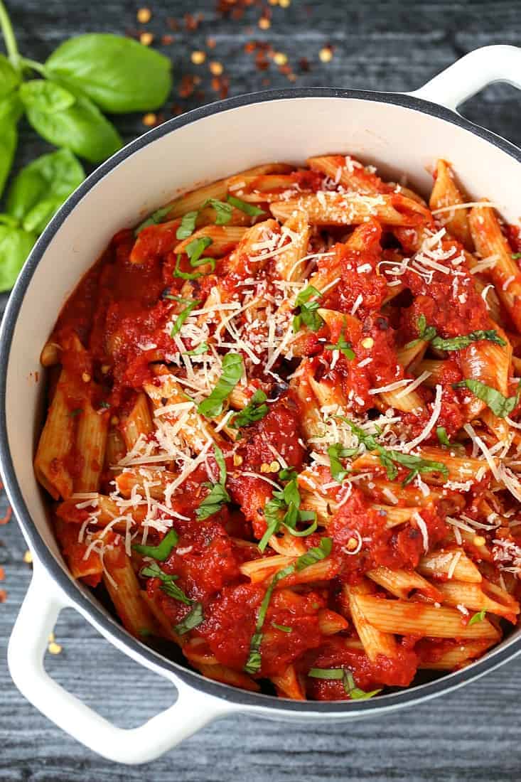 Homemade Pasta Arrabbiata Sauce in a pot with basil and cheese