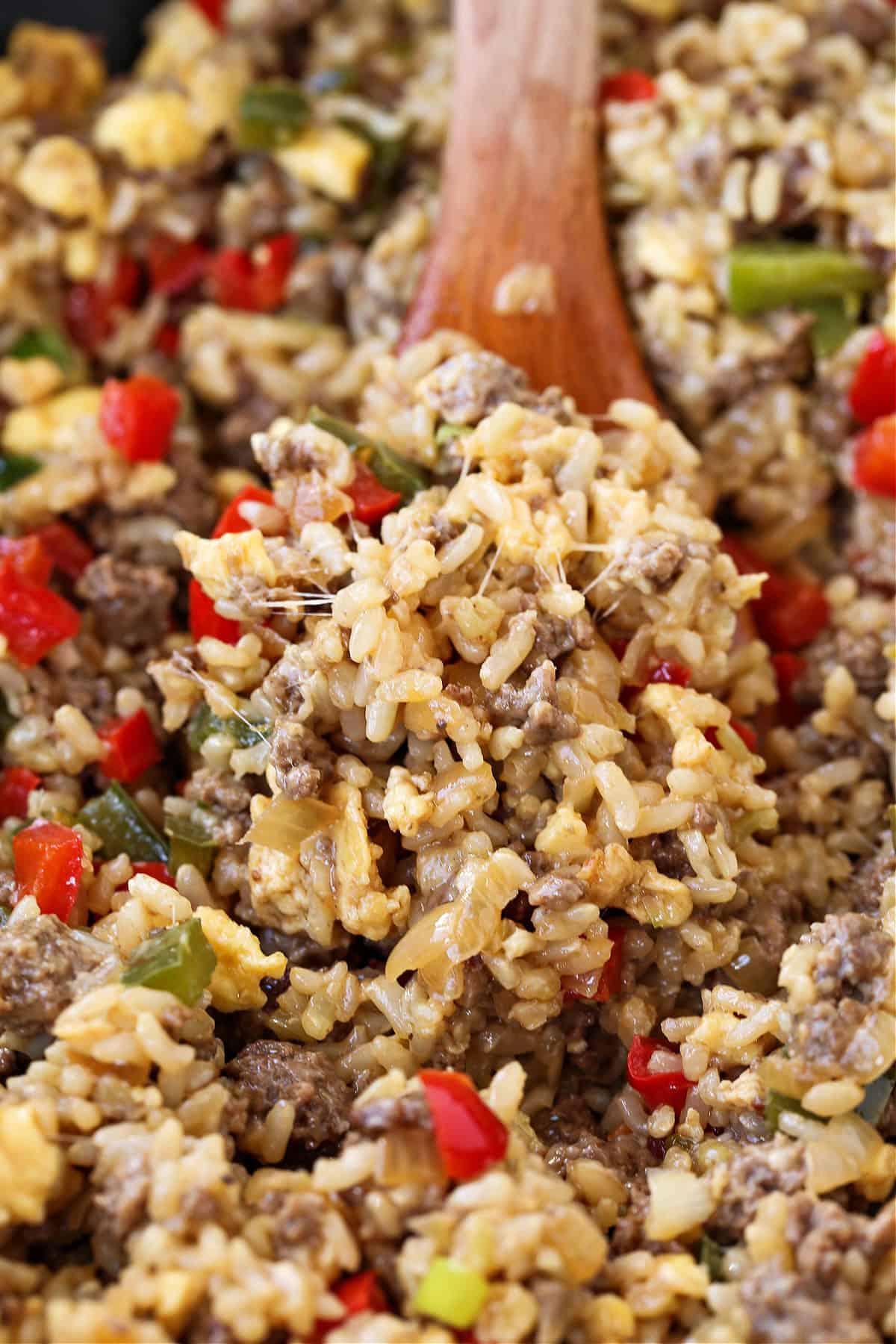 Philly Cheesesteak Fried Rice is the ultimate, comfort food dinner! Ground beef, peppers and gooey cheese make this fried rice irresistible! cheesy rice with ground beef and peppers