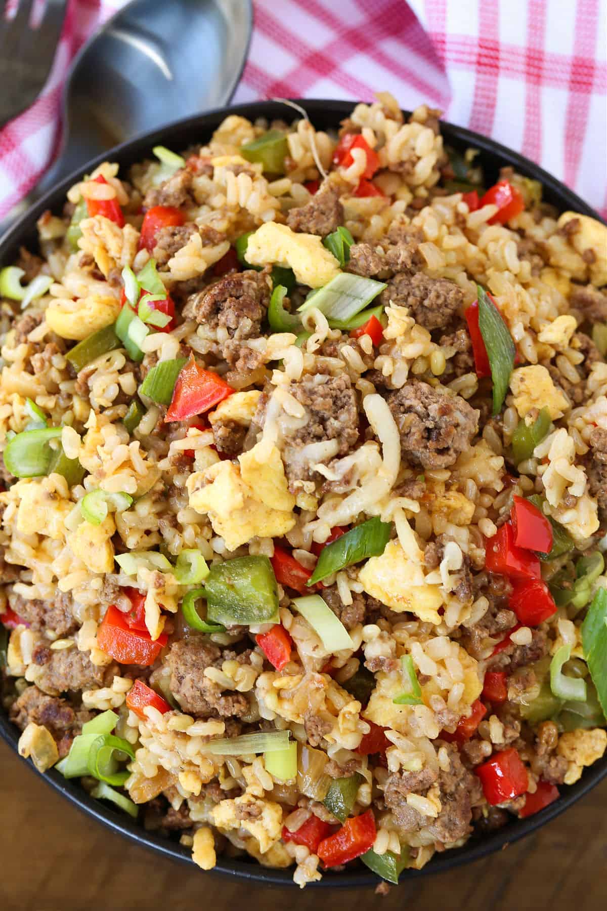 Philly Cheesesteak Fried Rice is the ultimate, comfort food dinner! Ground beef, peppers and gooey cheese make this fried rice irresistible! fried rice with ground beef, cheese and peppers