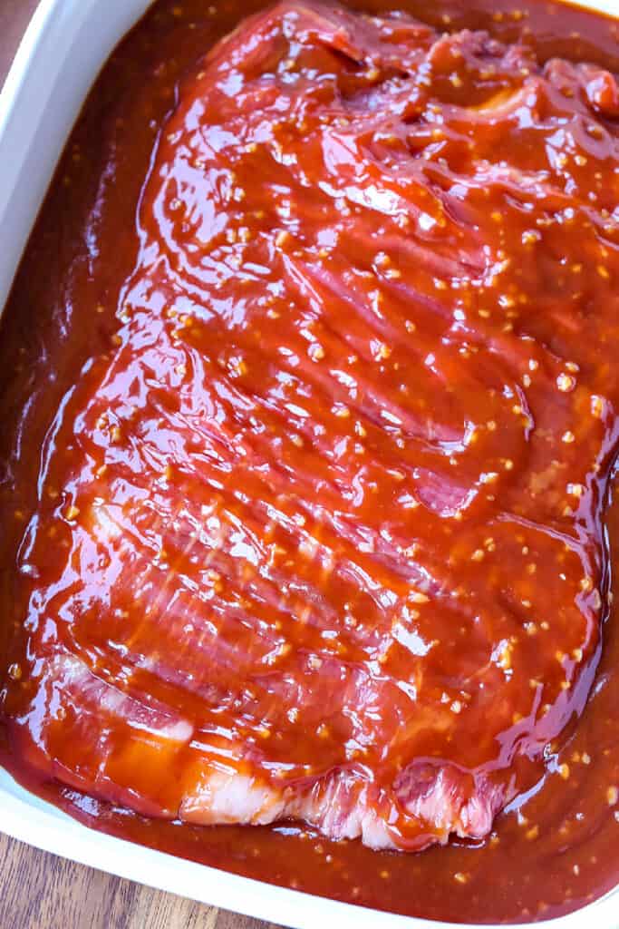 Our famous Whiskey Steak Marinade! Let this marinade work overnight for a tender, flavorful steak with a perfect caramelized crust! marinade over flank steak in dish