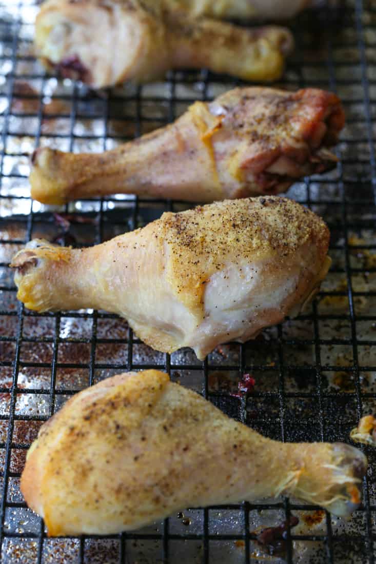 Baked chicken legs on a baking rack