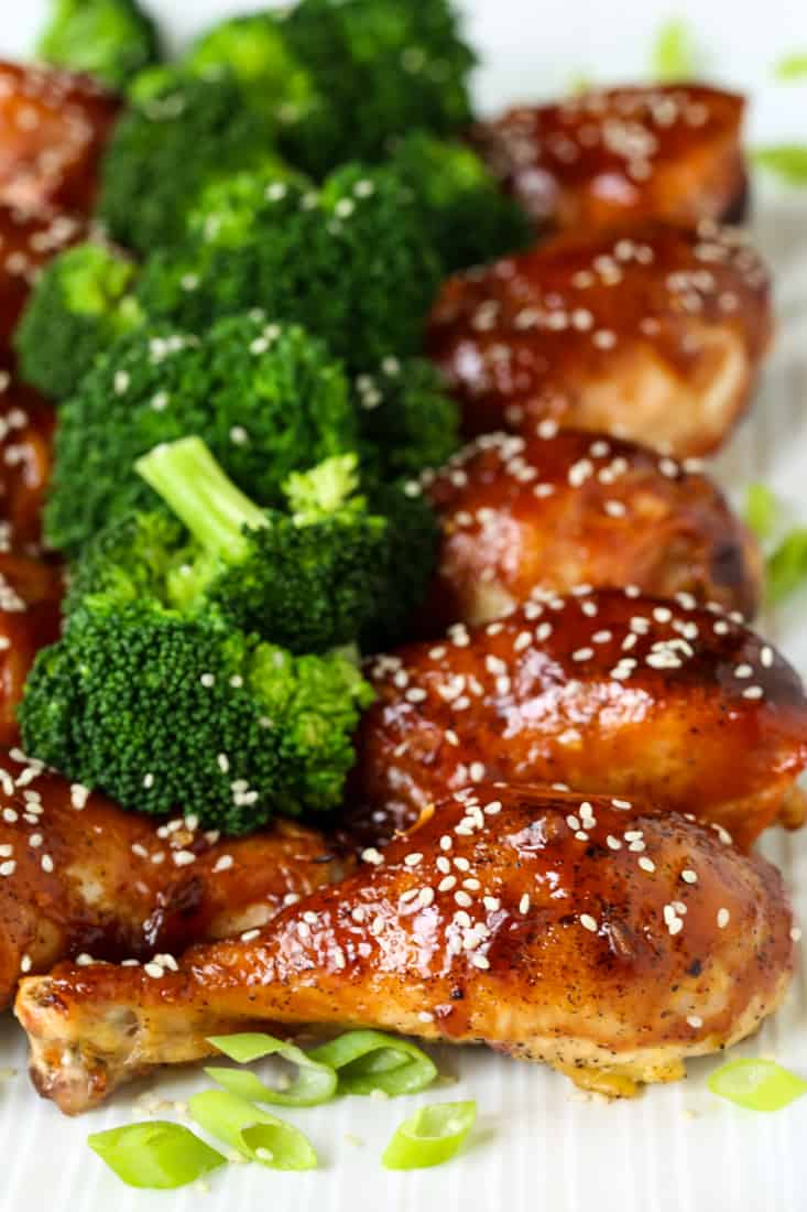 Asian Baked Chicken Legs on a platter with broccoli