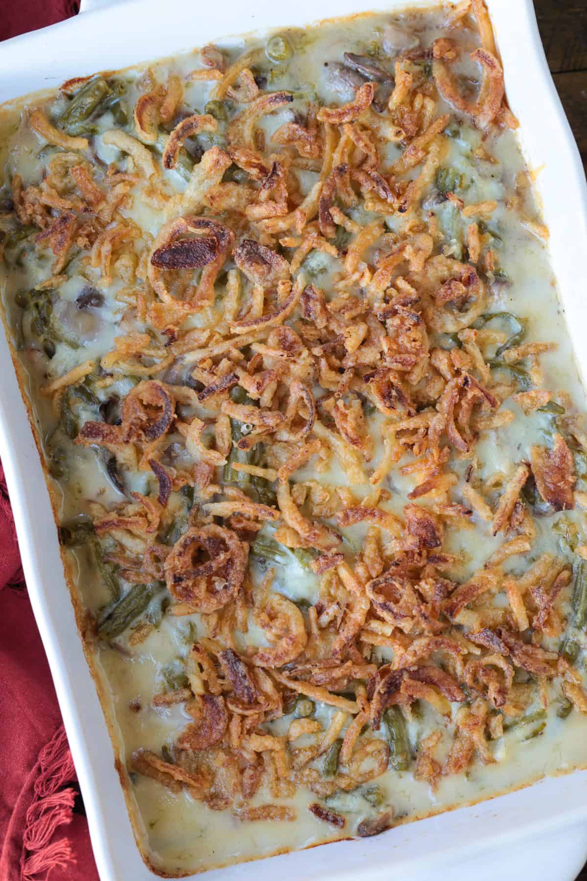 Cheesy Green Bean Casserole is sure to be a favorite Thanksgiving side dish! A scratch made cheesy cream sauce makes all the difference! casserole with green beans and fried onions