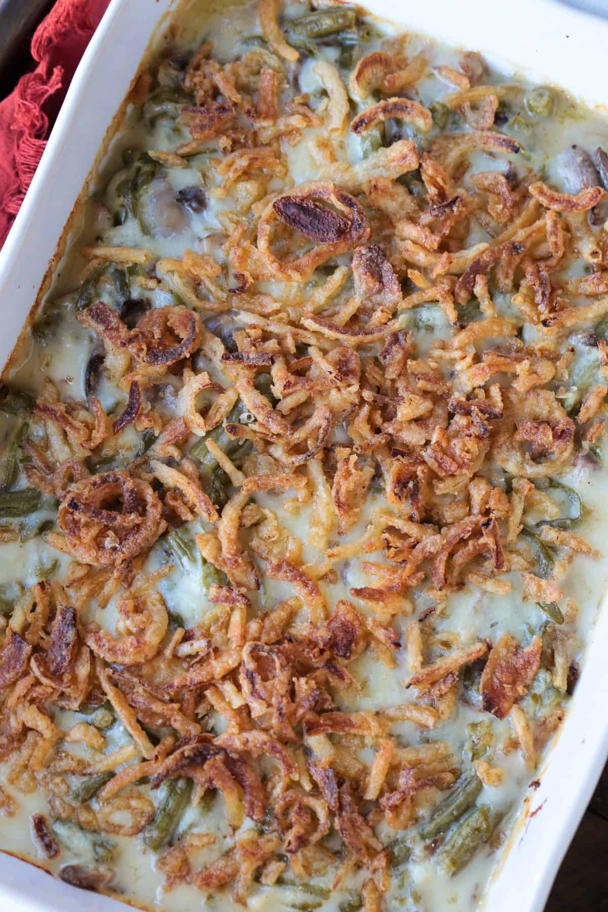 Cheesy Green Bean Casserole is sure to be a favorite Thanksgiving side dish! A scratch made cheesy cream sauce makes all the difference! green bean casserole with fried onions