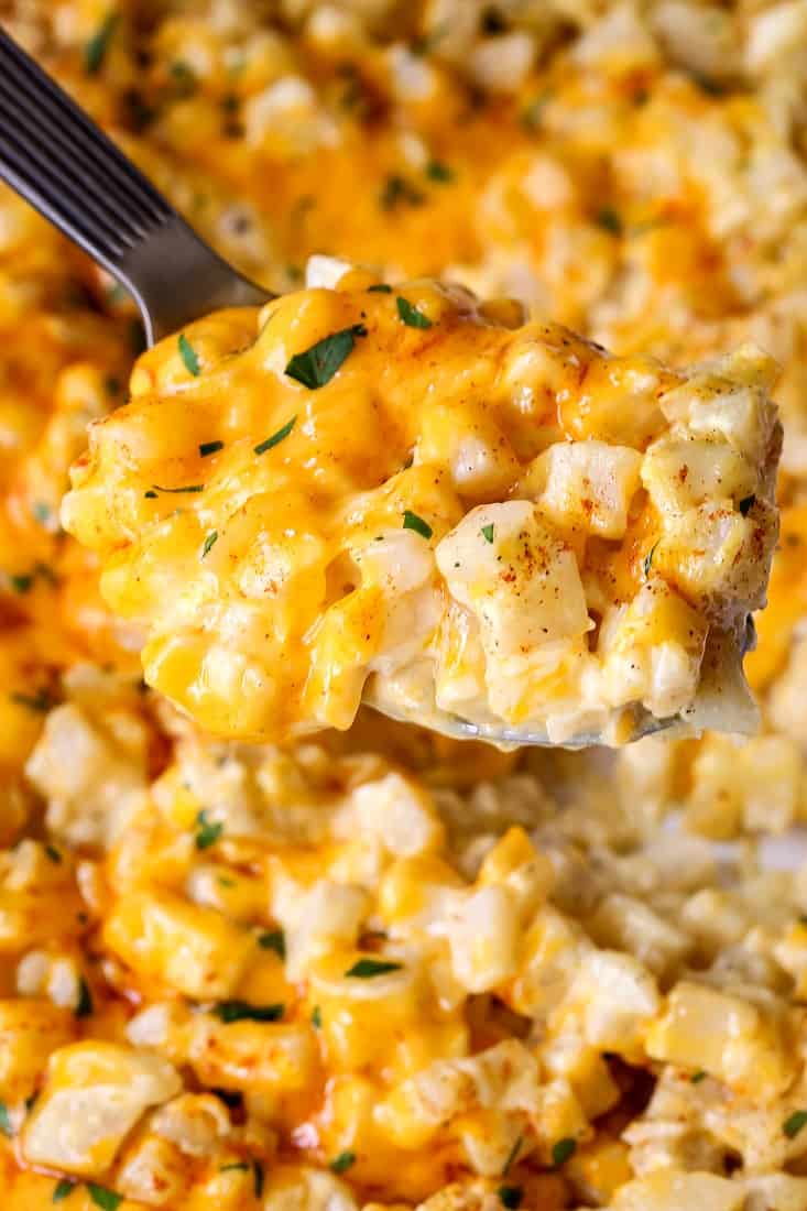 Cheesy Crock Pot Potatoes being served with a spoon