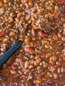 slow cooker baked beans with a spoon
