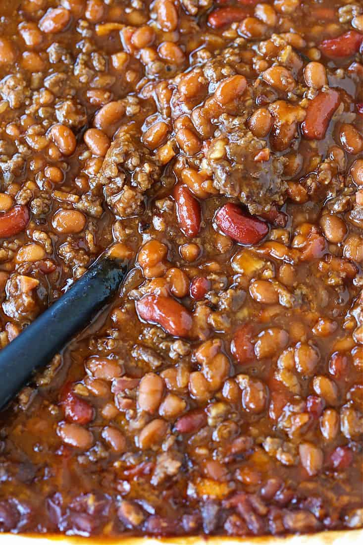 slow cooker baked beans with a spoon