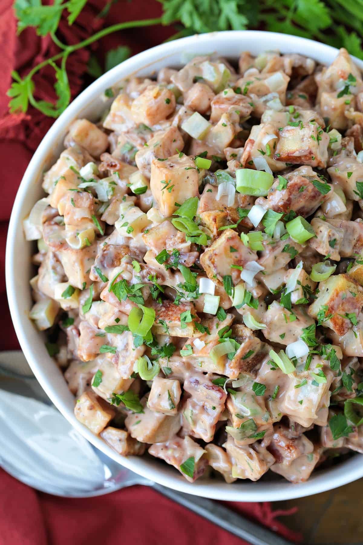 This Barbecue Roasted Potato Salad is unique side dish that everyone loves! Crispy, roasted potatoes tossed with a creamy, bbq dressing! roasted potato salad with barbecue and mayonnaise dressing in bowl from the top