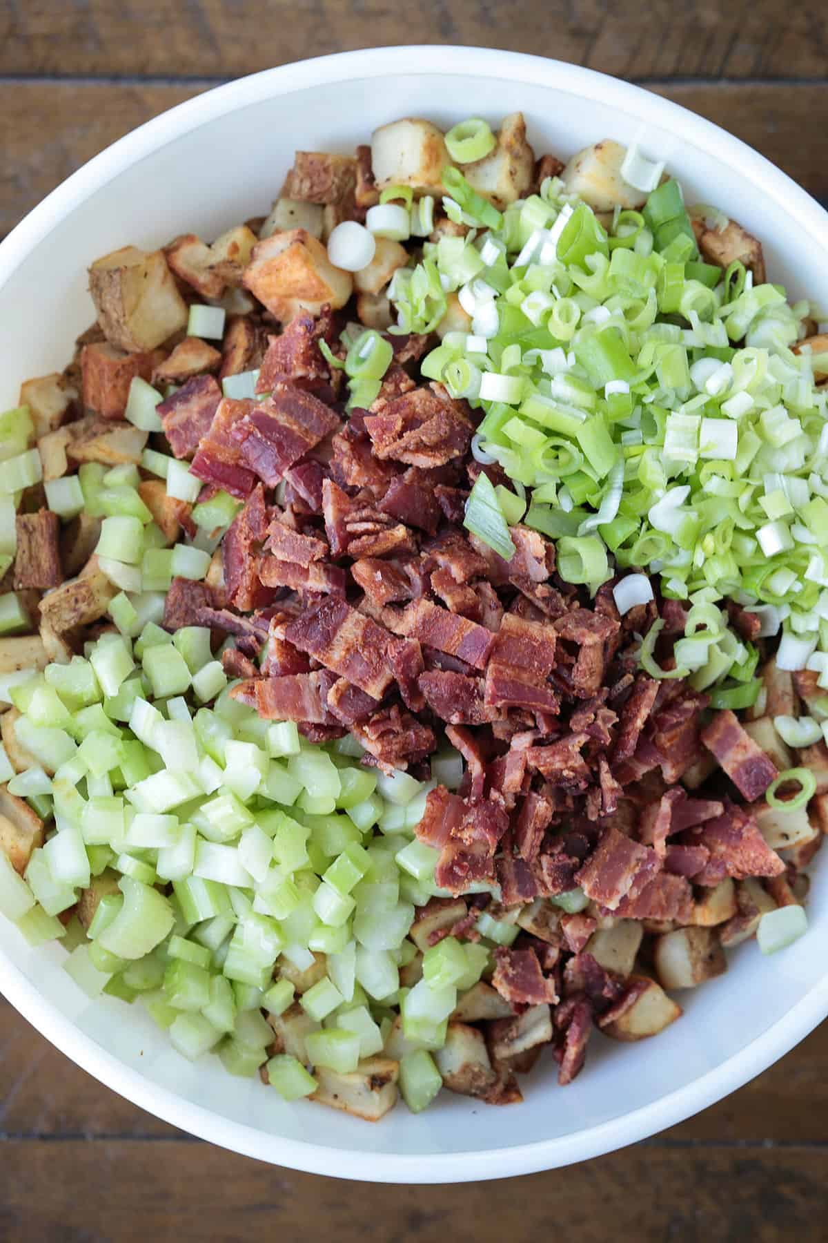 This Barbecue Roasted Potato Salad is unique side dish that everyone loves! Crispy, roasted potatoes tossed with a creamy, bbq dressing! ingredients in a bowl for making potato salad