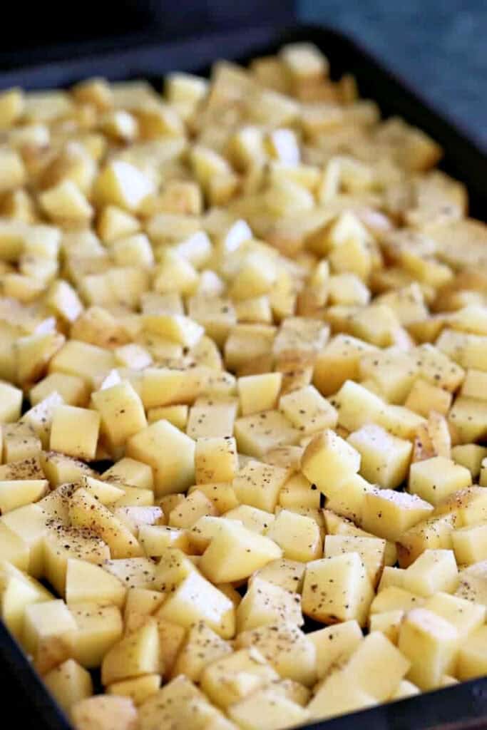 This Barbecue Roasted Potato Salad is unique side dish that everyone loves! Crispy, roasted potatoes tossed with a creamy, bbq dressing! diced potatoes on baking sheet