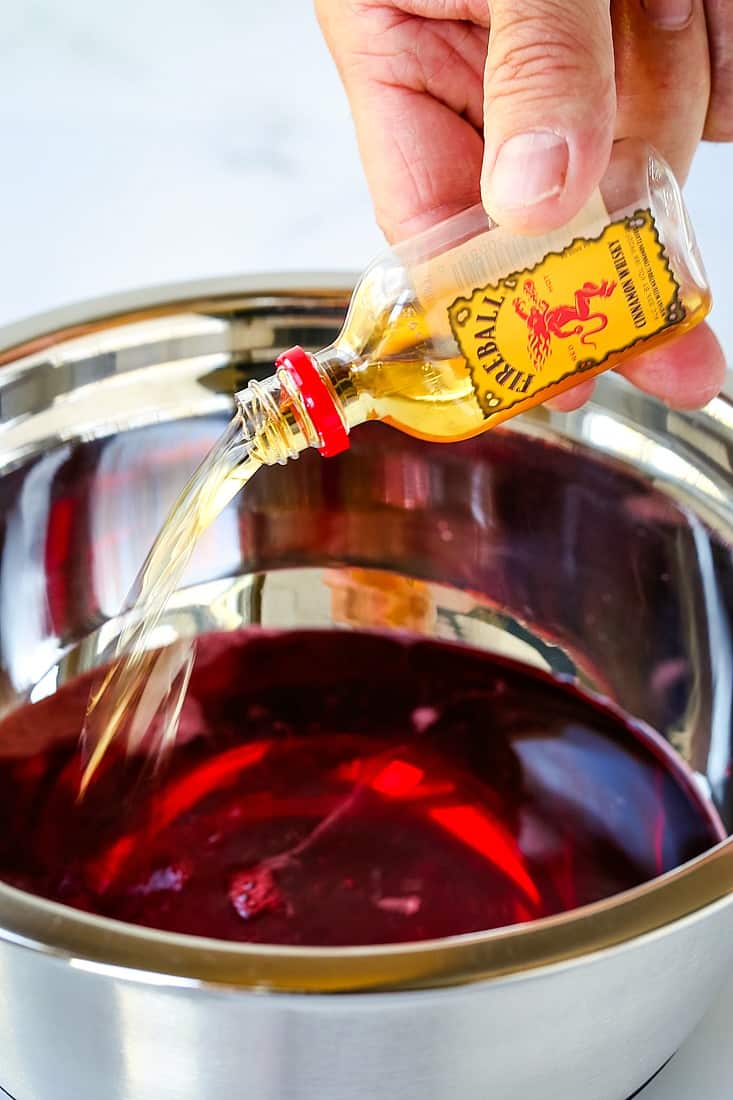 Pouring Fireball Whisky into a bowl with jello