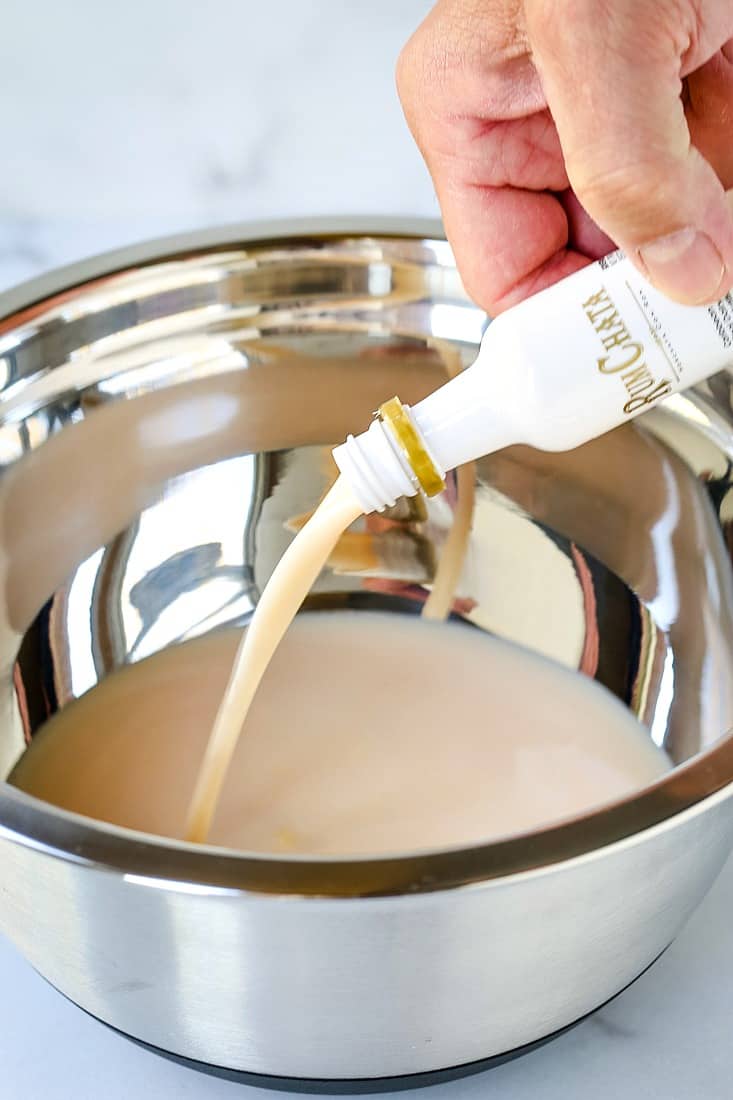 Pouring RumChat into a bowl with vanilla pudding