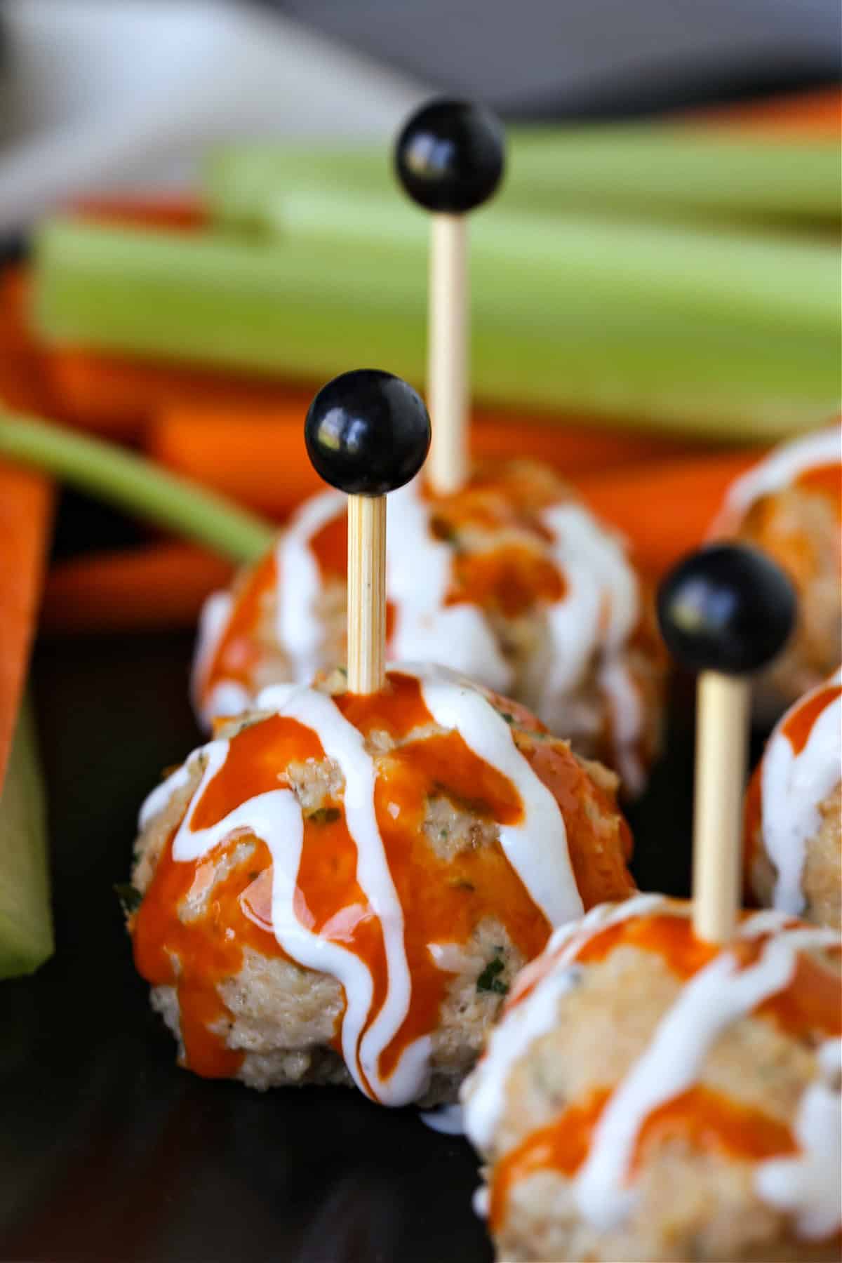 close up of a buffalo chicken meatball with toothpick