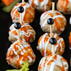 chicken meatballs on serving platter drizzled with sauce