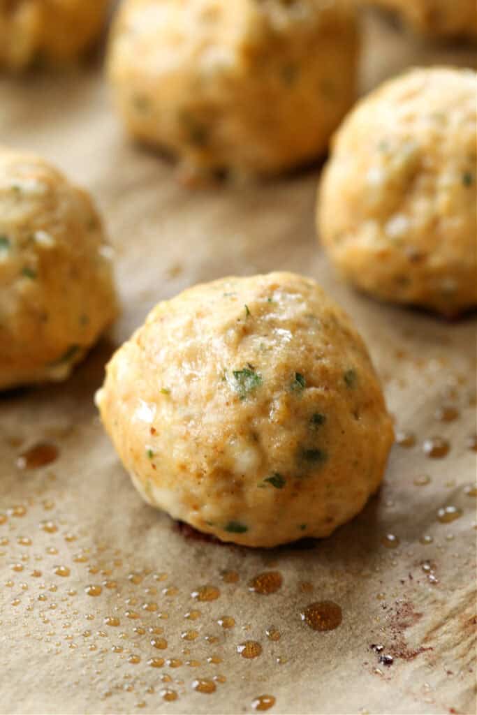 baked chicken meatballs on a baking sheet