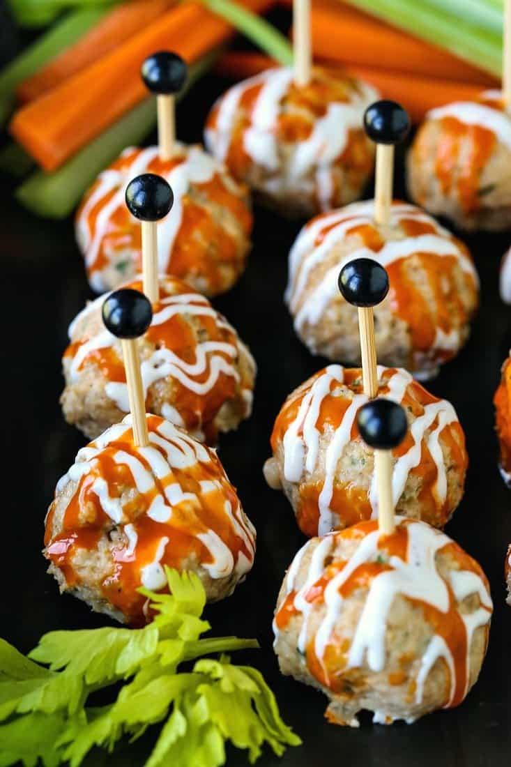 Buffalo Chicken Meatballs drizzled with ranch and hot sauce