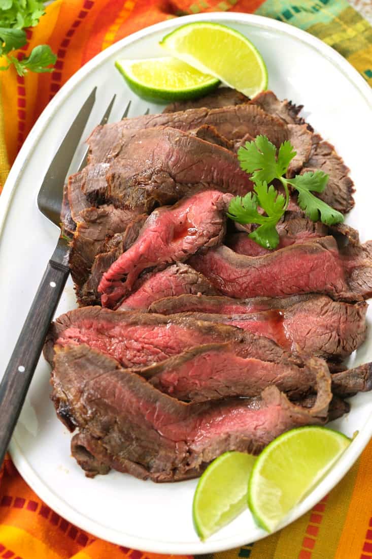 Flank steak on a platter with Fiesta Steak Marinade