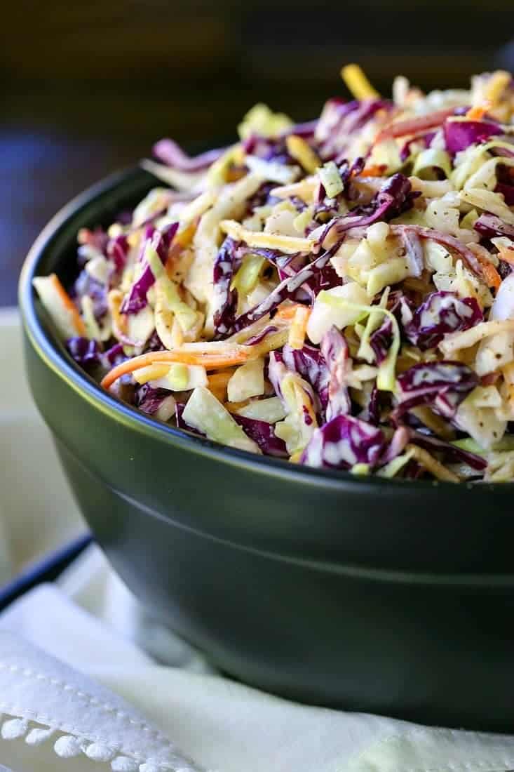 Coleslaw in a black bowl from the side