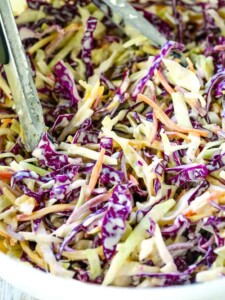 Super Creamy Coleslaw recipe in a bowl with tongs