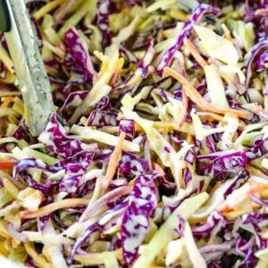 Super Creamy Coleslaw recipe in a bowl with tongs