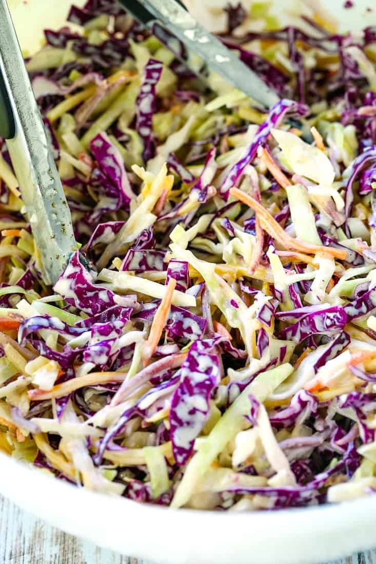 Super Creamy Coleslaw recipe in a bowl with tongs