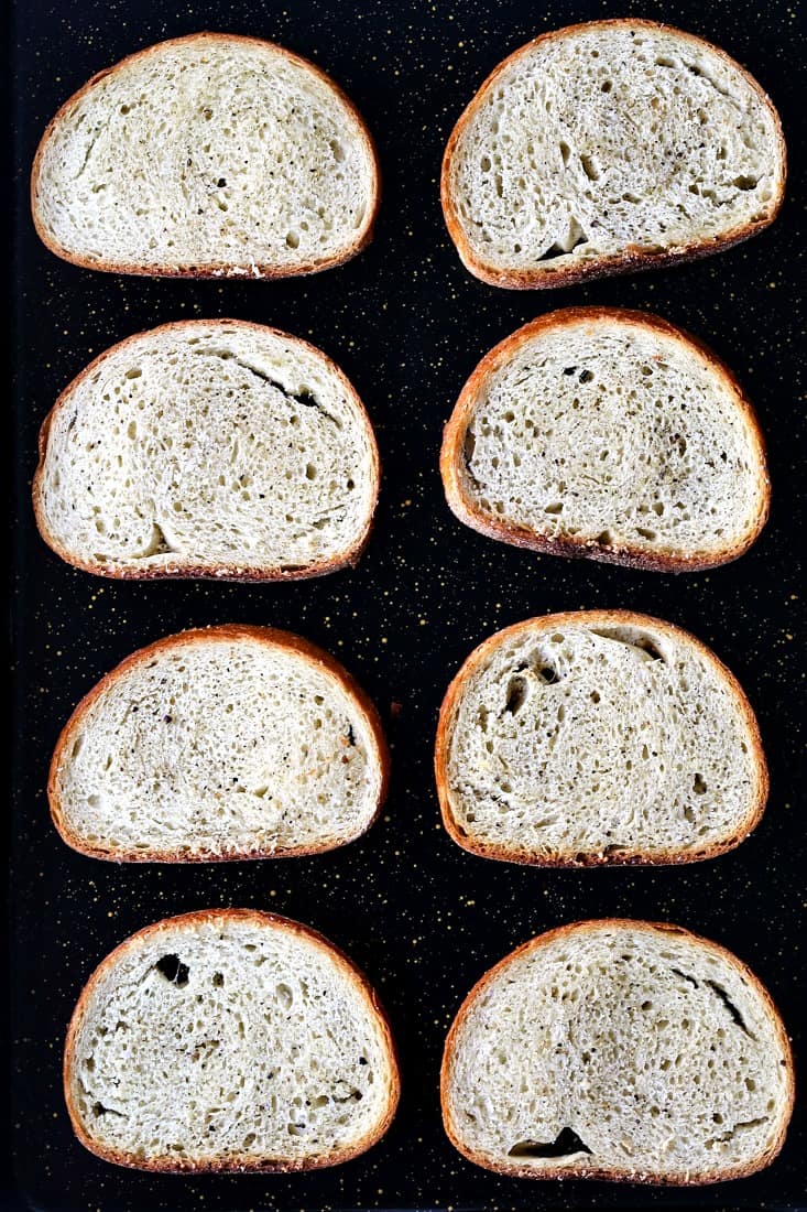 Sliced bread on a baking sheet for cheese bread appetizers