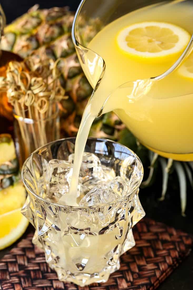 Pineapple Whiskey Lemonade being poured from a pitcher