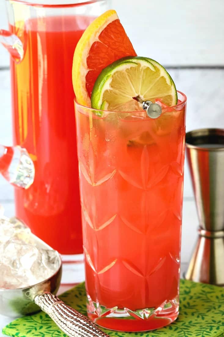 Sea Breeze drink in a glass with a pitcher