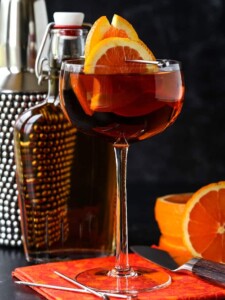 Sidecar cocktail with shaker and orange garnish