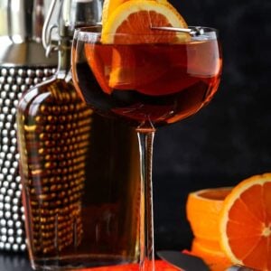 Sidecar cocktail with shaker and orange garnish