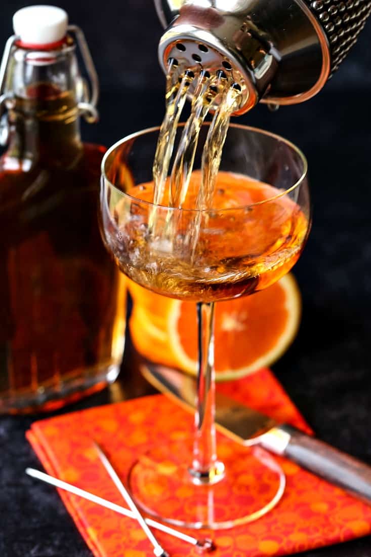 Amaretto sidecar drink being poured from cocktail shaker