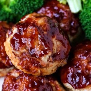 mini meatloaf muffins on a plate with broccoli