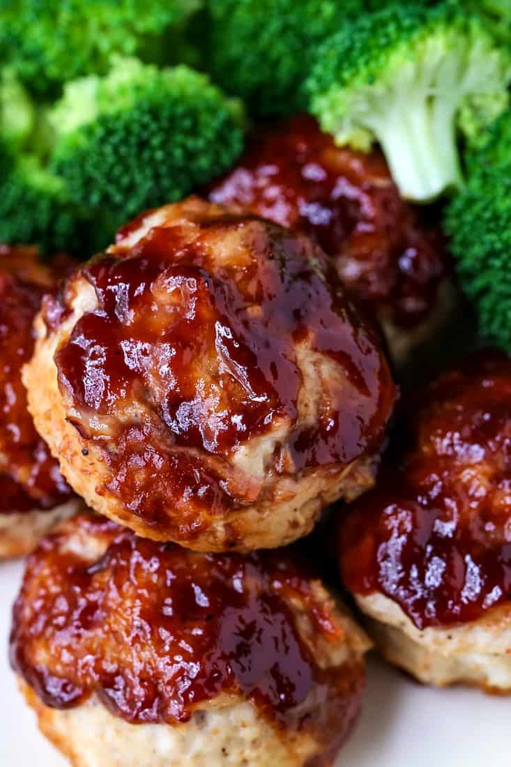 mini meatloaf muffins on a plate with broccoli
