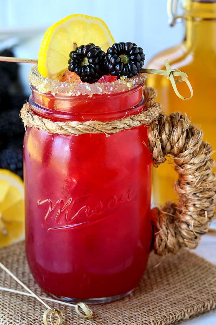blackberry bourbon lemonade in mason jar glass
