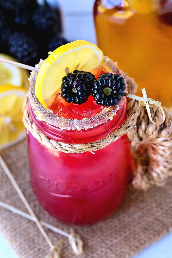 Bourbon lemonade with blackberries and lemon slice for garnish