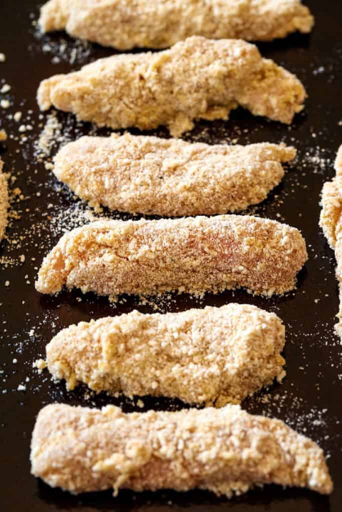 breaded chicken tenderloins on sheet pan