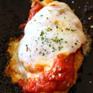 single chicken tenderloin with melted cheese and sauce