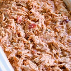 Pulled chipotle chicken being heated in a crock pot.