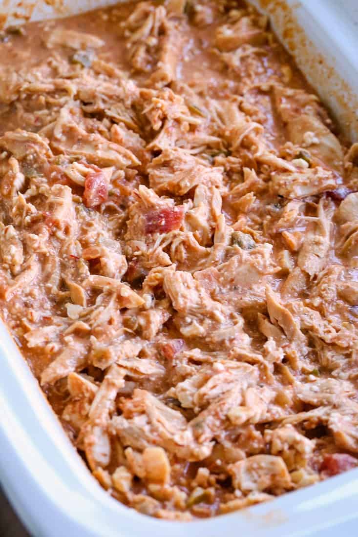 Pulled chipotle chicken being heated in a crock pot.