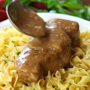 pork chop with gravy being poured over