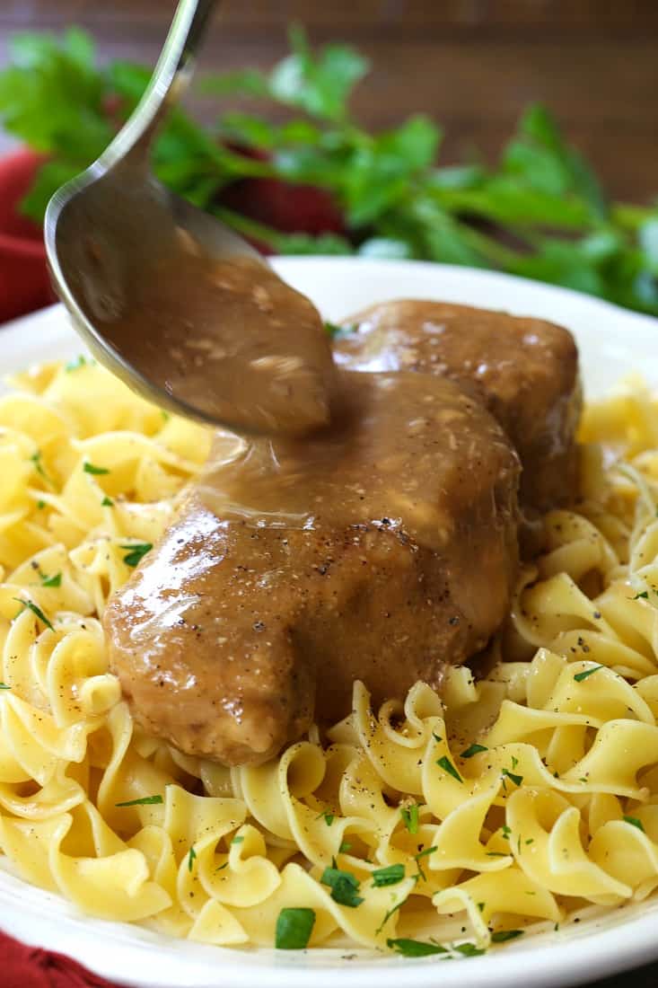 pork chop with gravy being poured over