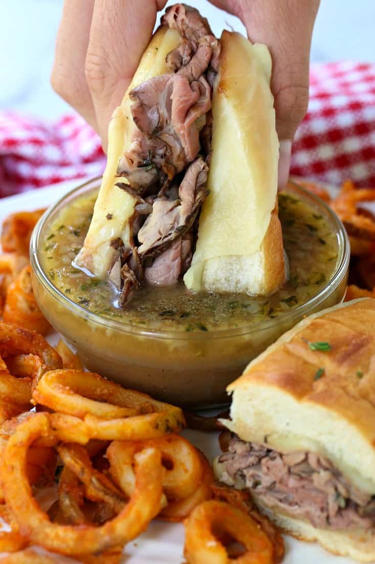 Easy French Dip Sandwich dipping in au jus