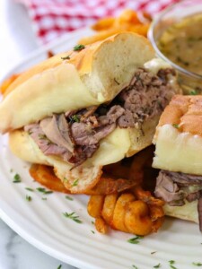 French Dip Sandwich cut on plate with fries